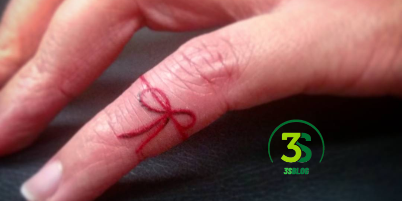 red string couple tattoo